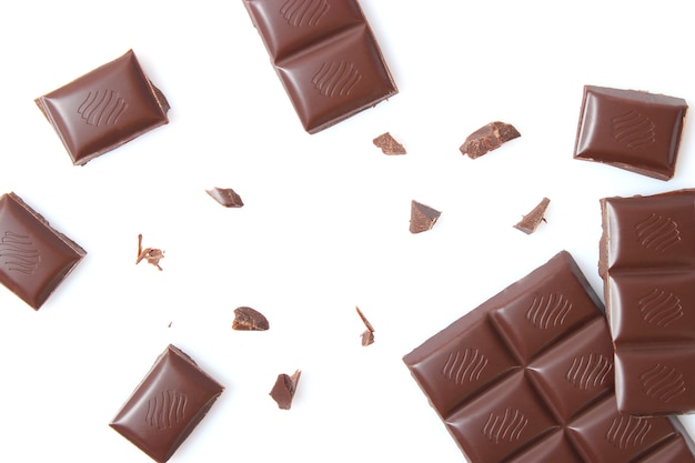 Pieces of chocolate isolated on white closeup