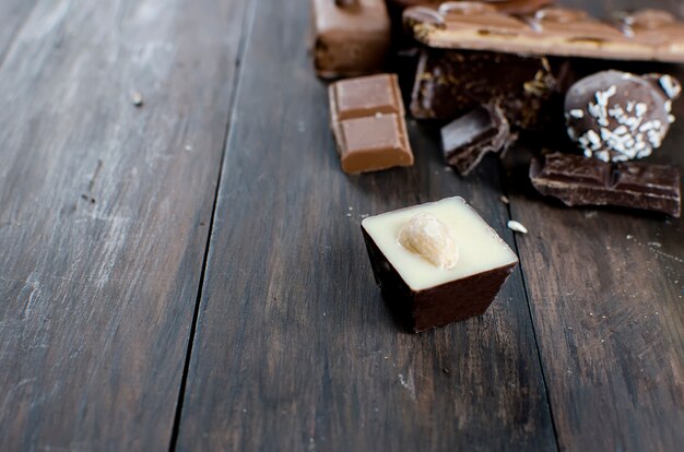 Pieces of chocolate on wooden table