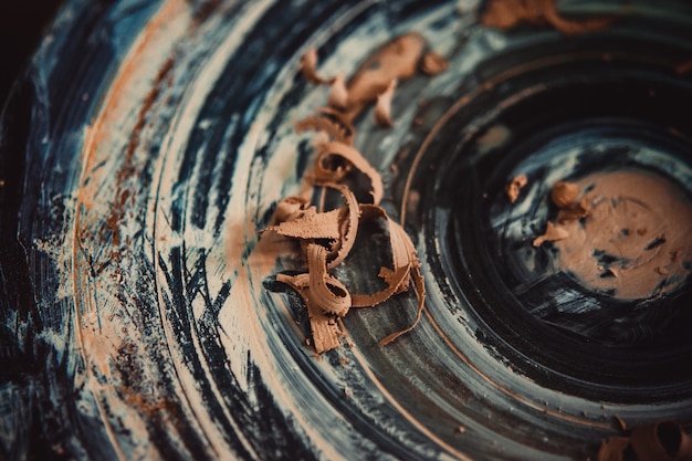 Foto pezzi di argilla sul primo piano del tornio da vasaio. ceramiche da officina. mastro coccio. tradizioni culturali. fatto a mano. mestiere. tornio da vasaio contorto.