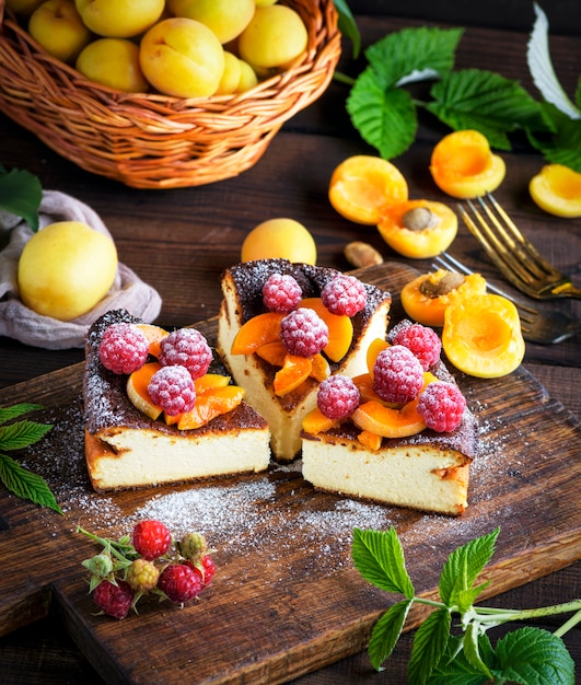 Pieces of cottage cheese pie with strawberries and apricots