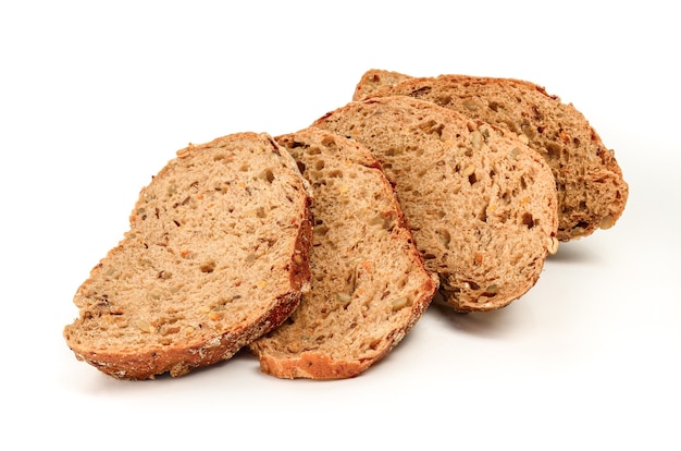 The pieces of cut brown bread close on a white surface.