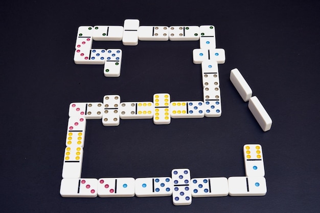 Pieces of dominoes on black table