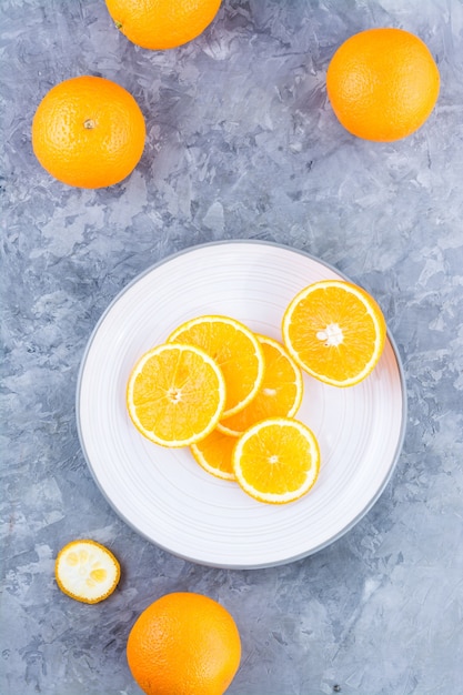 Pieces of fresh orange on a plate on the table