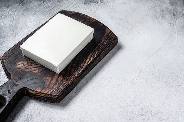 Pieces Of Fresh Paneer Cheese on a cutting board.   Top view.