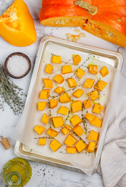 Pieces of fresh raw organic pumpkin are ready for baking