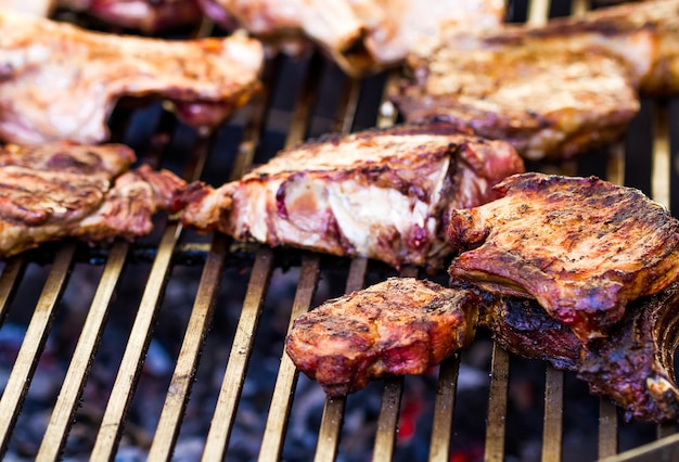 Pieces of fried meat on the grill