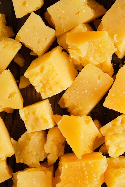 Photo pieces of hard parmesan cheese. delicious aged cheese as an appetizer or as an independent dish.