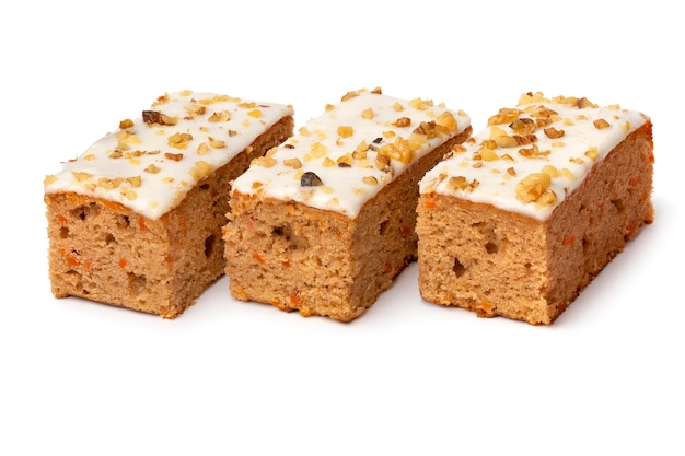 Pieces of homemade carrot cake on white background