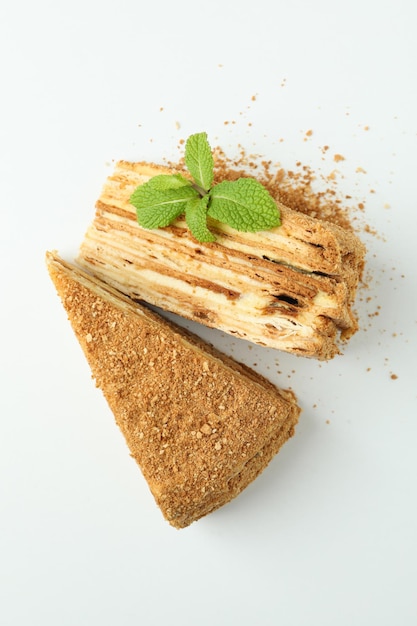 Pieces of honey cake on white background