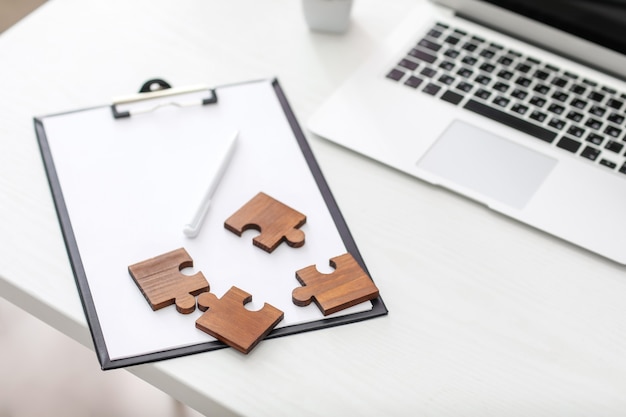 Pieces of jigsaw puzzle on office table