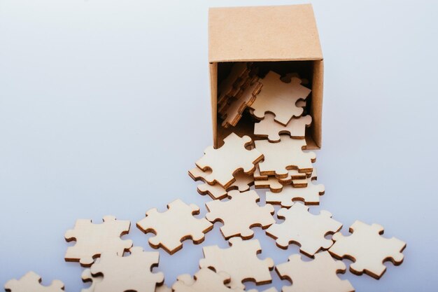 Pieces of jigsaw puzzle out of box as problem solution concept