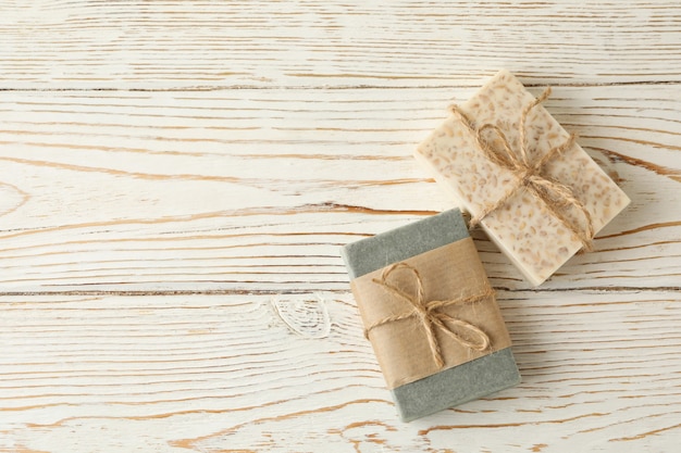 Pieces of natural handmade soap on wooden background