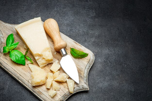 Pieces of parmesan cheese on concrete table