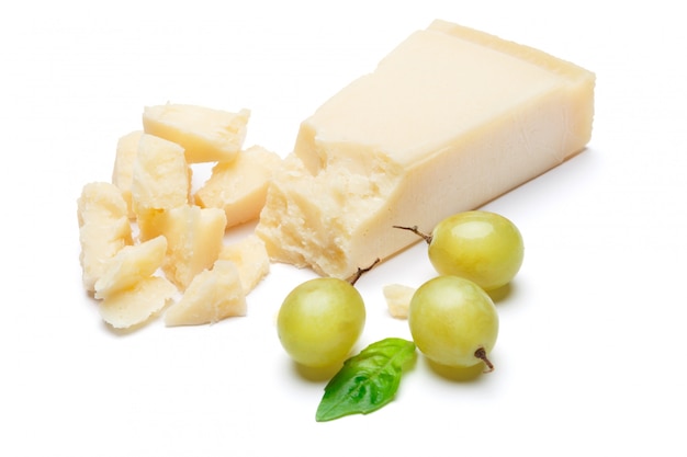 Pieces of Parmesan cheese on white table