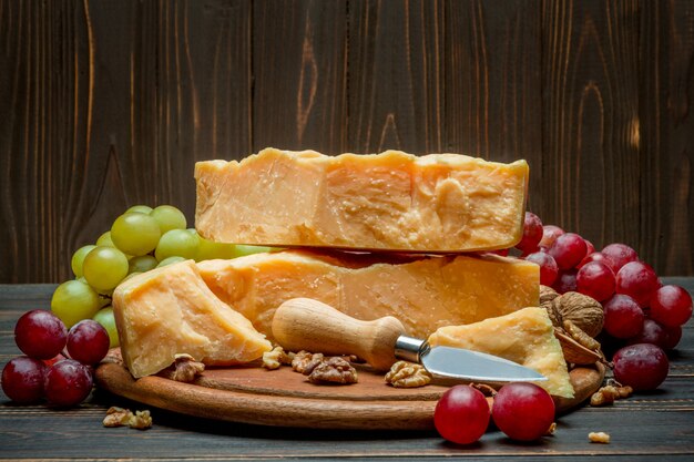 Pieces of parmesan or parmigiano cheese and grapes