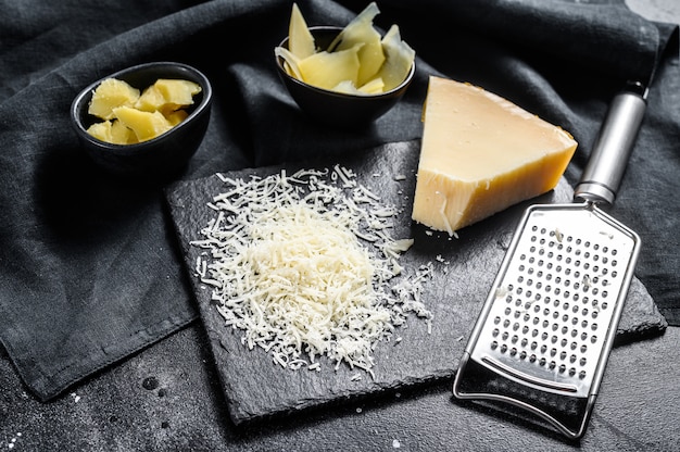 Photo pieces of parmigiano reggiano hard cheese.