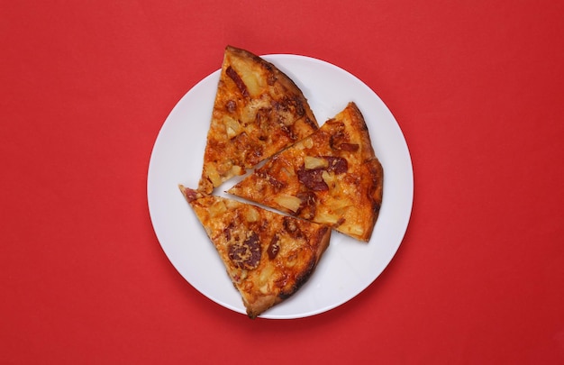 Pieces of pizza on plates Red background