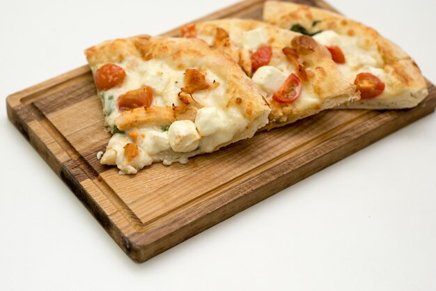 Pieces of pizza on a wooden board