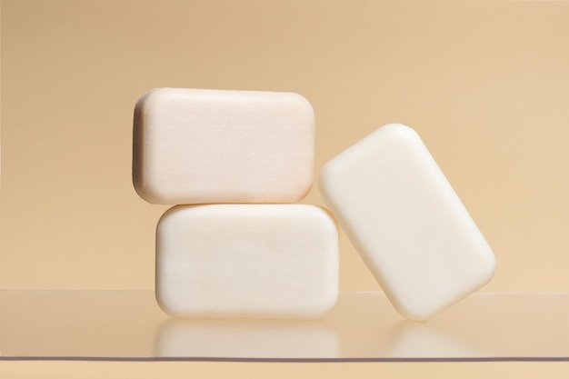 pieces of plain natural soap on a beige isolated background image for your design