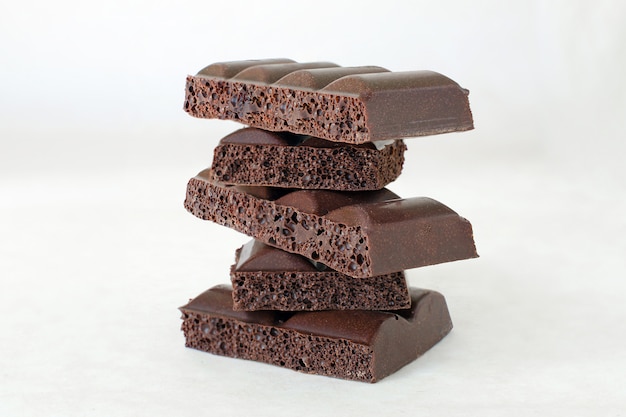 Pieces of porous black chocolate stacked