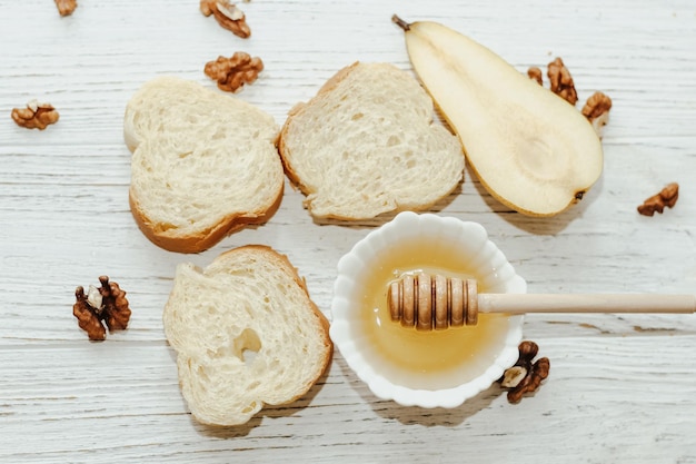 Pieces of ripe pear with croutons with honey on the kitchen table