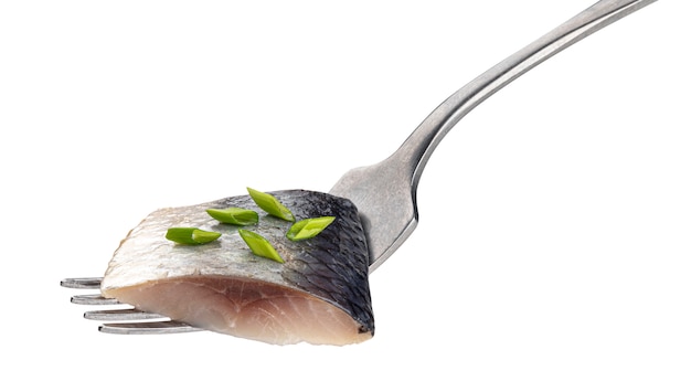 Pieces of salted herring on fork