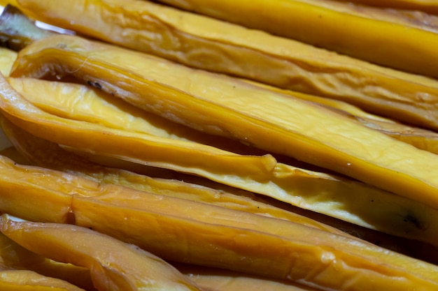 Pieces of salty smoked squid on the seafood market