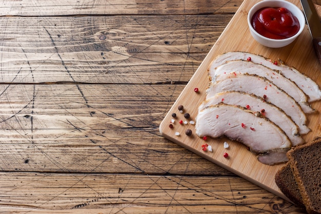 Pieces of smoked boiled pork on a wooden rustic Board