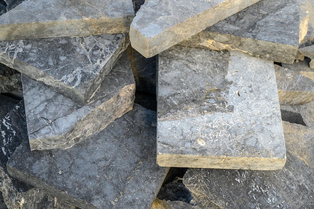 pieces of stone for paving lie in a heap as a background 3