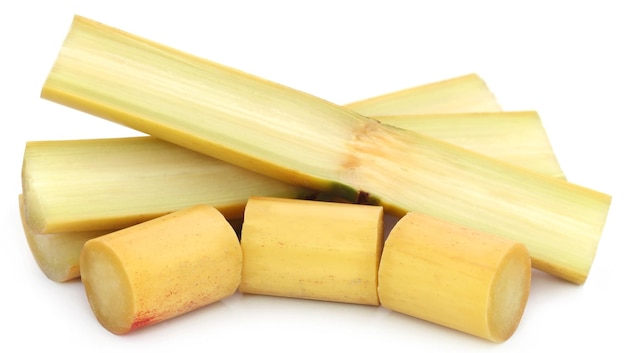 Pieces of sugarcane over white background