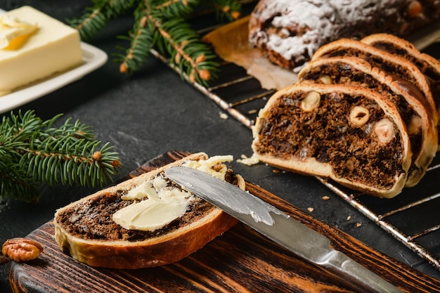 Pieces of Swiss Pear Bread - BÃ¼ndner Birnbrot, close up on the table. Traditional Christmas and New Year's meal. Birnbrot is smeared with butter and served with coffee. Selective focus