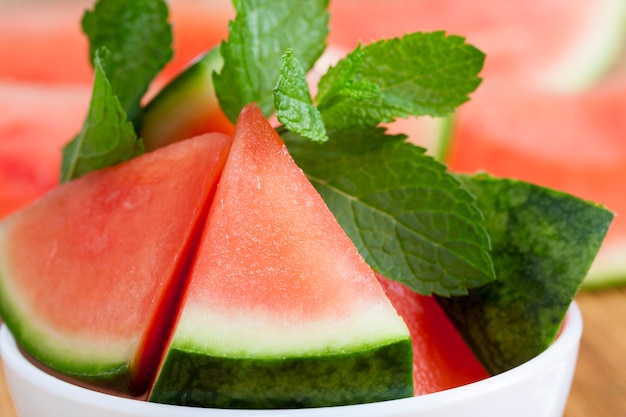 Photo pieces of watermelon and petals of mint green