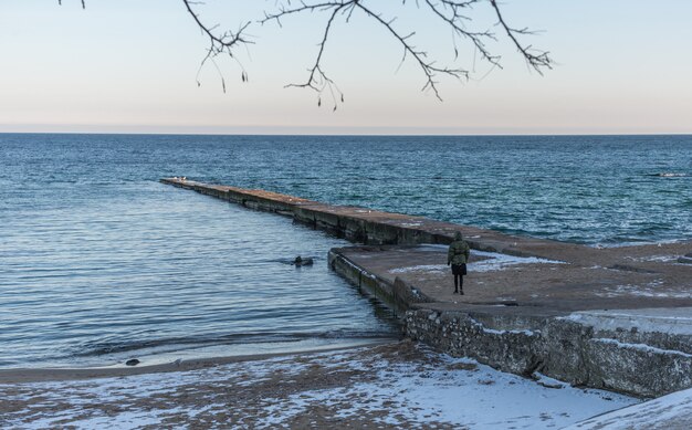 Pier on the beach in winter day