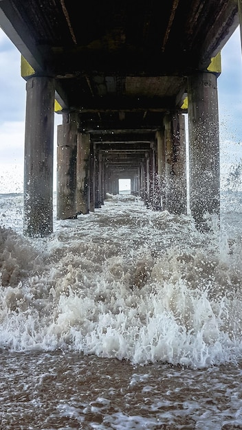 pier on the beach below with waves