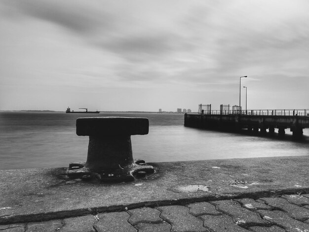 Pier by sea against sky