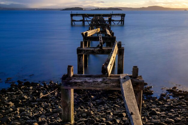 Pier on lake against sky