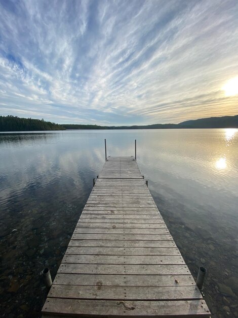 Pier over lake against sky