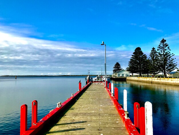 Pier over lake against sky