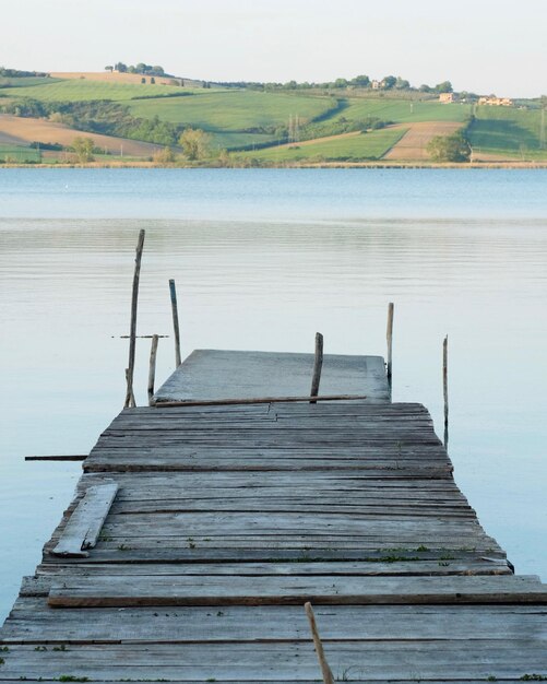 Pier over lake against sky