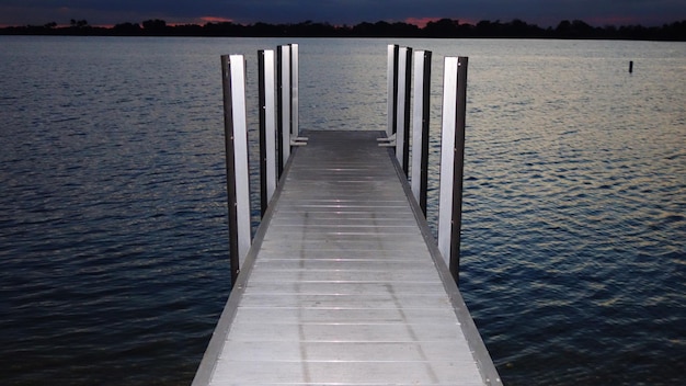 Pier over lake against sky