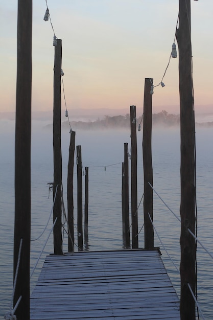 Pier on the lake in a foggy morning