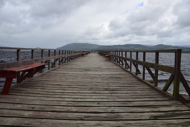 Pier over lake huillinco from which the naturalist charles\
darwin left on his journey through different lakes chile