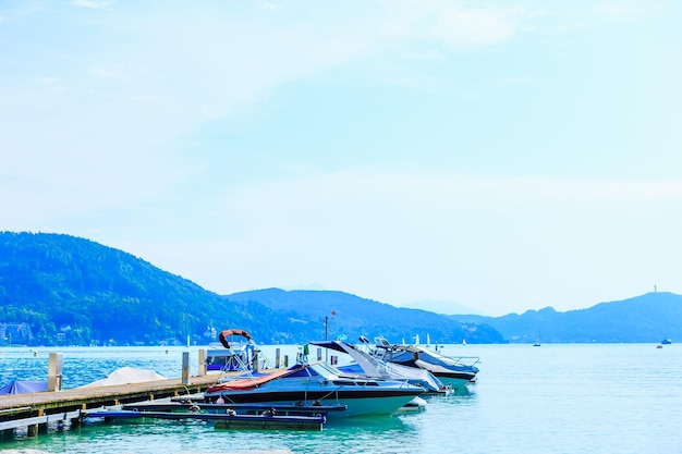 Pier and motor boats on a mountain lake beautiful view of the l