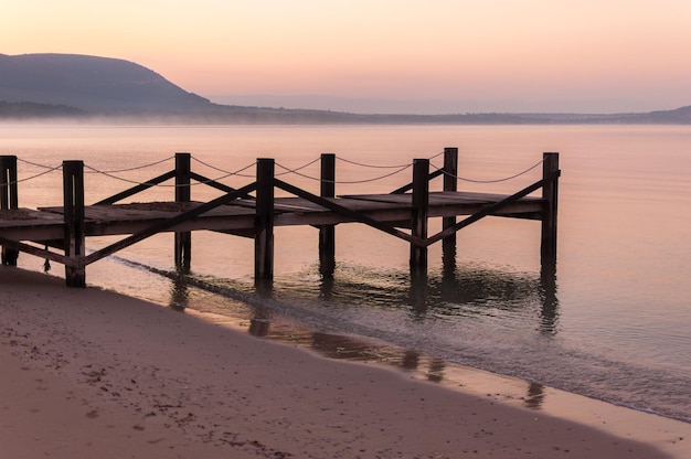 Pier on the Mugoni beach at sunrise