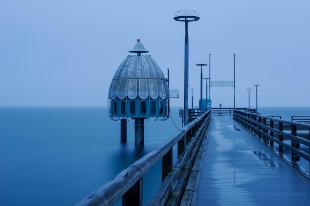 Pier over sea against clear sky