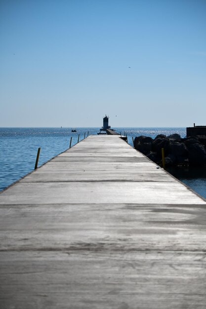 Pier over sea against clear sky