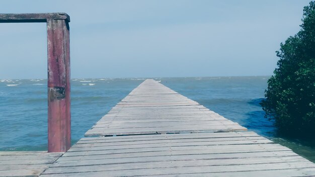 Pier over sea against clear sky