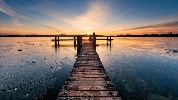 pier over sea against sky during sunset