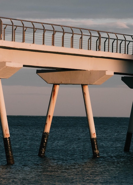 Pier over sea against sky during sunset