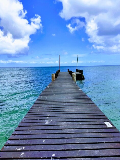 Pier over sea against sky